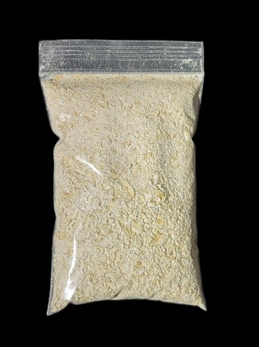 100g ziplock bag with ground oat flakes on a black background - food for slime mold Physarum polycephalum