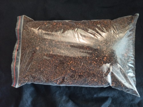 Transparent package of dark moist breeding substrate for isopods.